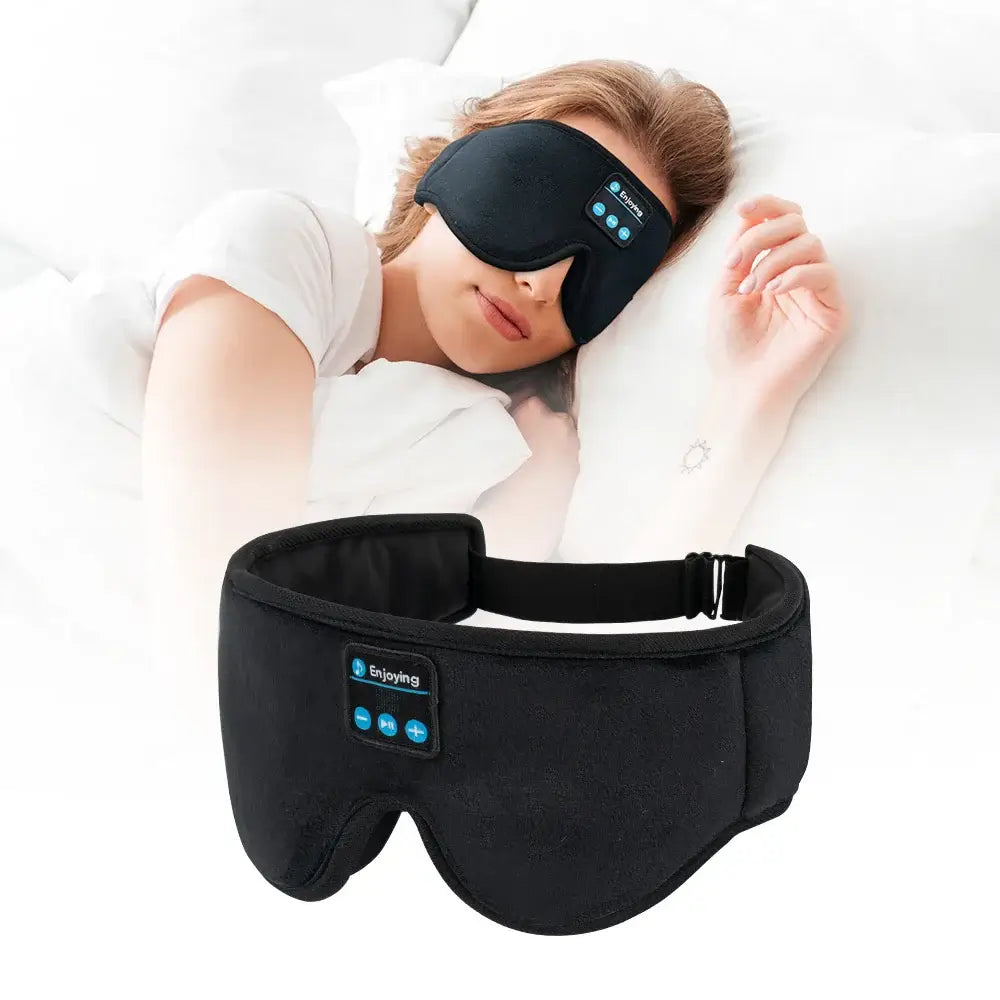 Person wearing a black Bluetooth sleep mask with a control panel, lying on a pillow.