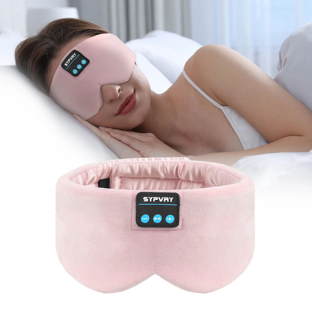 Woman wearing a pink sleep mask with a SYPVRY branded device on a white pillow.